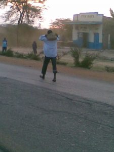 Crazy guy carrying a rock in Tala, Kenya